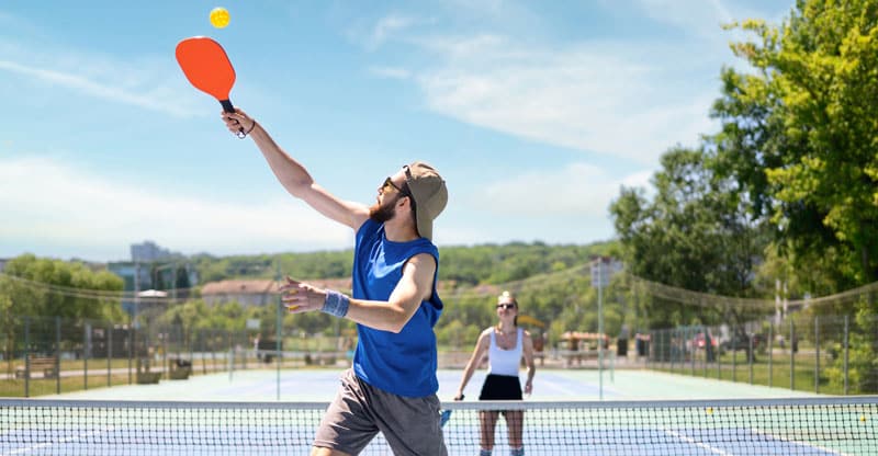 Couple playing pickleball.