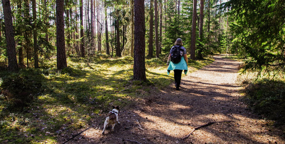 woman hiking with a dog