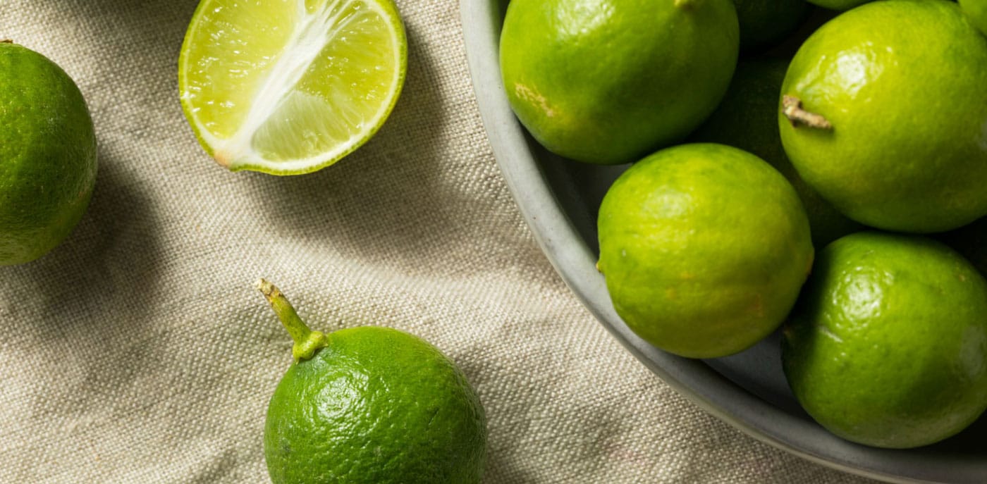 Key limes overflowing in a bowl